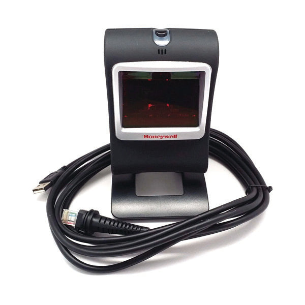 A PCPOS Systems Honeywell Genesis 7580 black desktop barcode scanner stands upright on a white background, with USB and Ethernet cables coiled around its base.