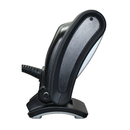 A close-up side view of the PCPOS Systems Honeywell Genesis 7580, a black handheld USB barcode scanner with coiled cable, desktop compatible and resting on its base against a white background.