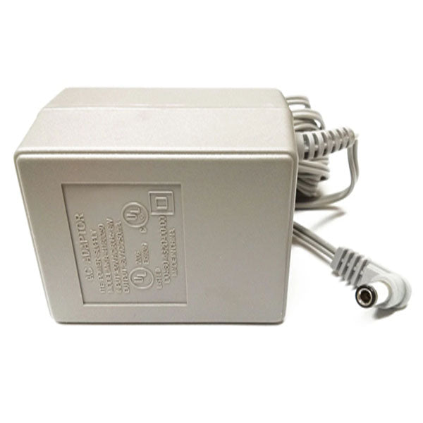 A rectangular gray Nortel Power Supply ("USED Like New"), Input: 120VAC 60Hz, Output: 12V 1.0A 20W, with a coiled power cord and cylindrical plug, rests on a white surface. Model for Meridian Phones. Specs are printed on one side.