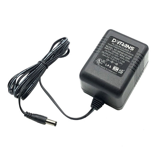 The PCPOS Systems Protran Power Supply delivers 12V 1.0A (20W) from 120VAC/60Hz input, features a long cable with barrel connector, and displays specs and branding on the label. Designed for standard wall outlets.