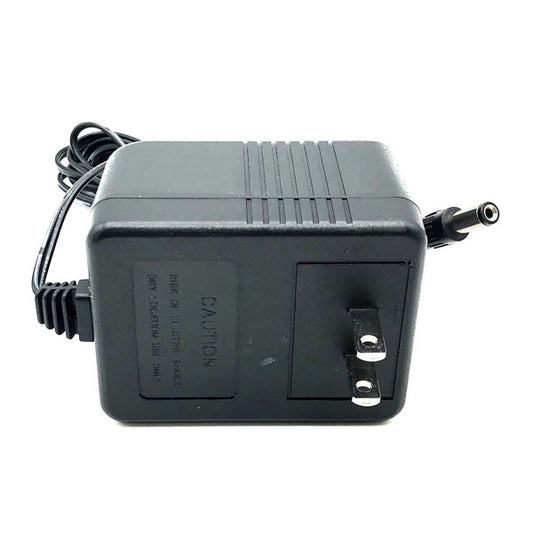 A black PCPOS Systems Protran Power Supply (input: 120VAC 60Hz, output: 12V 1.0A 20W) with a two-prong plug and a coiled barrel-connector cord is displayed on a white background.