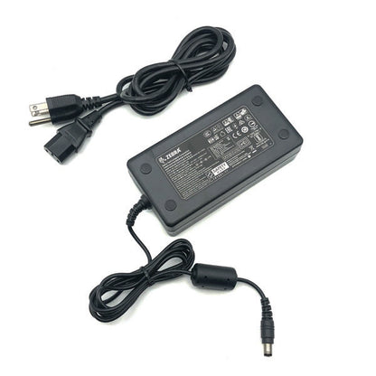 A black PCPOS Systems Zebra AC adapter (NCR Part #: 8770308477, VPN: P1086001-006) for ZD620 printer, with attached cables—one end standard plug, the other cylindrical connector; label lists specs for Zebra printer use.