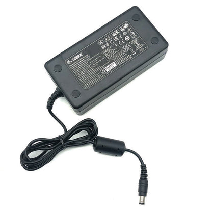 A PCPOS Systems NCR 8770308477 Zebra AC Adapter (P1086001-006) for ZD620 printers features a black rectangular body, attached cable with cylindrical plug, and a top label displaying technical specs.
