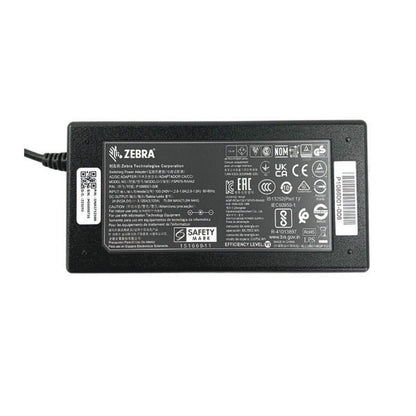 Rectangular black PCPOS Systems Zebra AC Adapter (NCR #8770308477, VPN P1086001-006) with safety labels and barcode on top, left-side power cord; ideal as a ZD620 printer power supply.