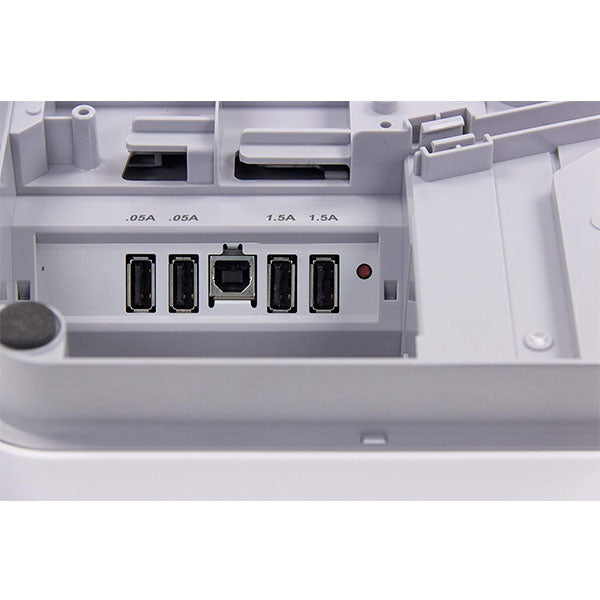 A close-up of the mPOP POS rear panel by PCPOS Systems reveals five USB ports in a row, labeled with power ratings: two at 0.5A and three at 1.5A, designed for powering subscription service devices. The light gray plastic casing provides a sleek finish.